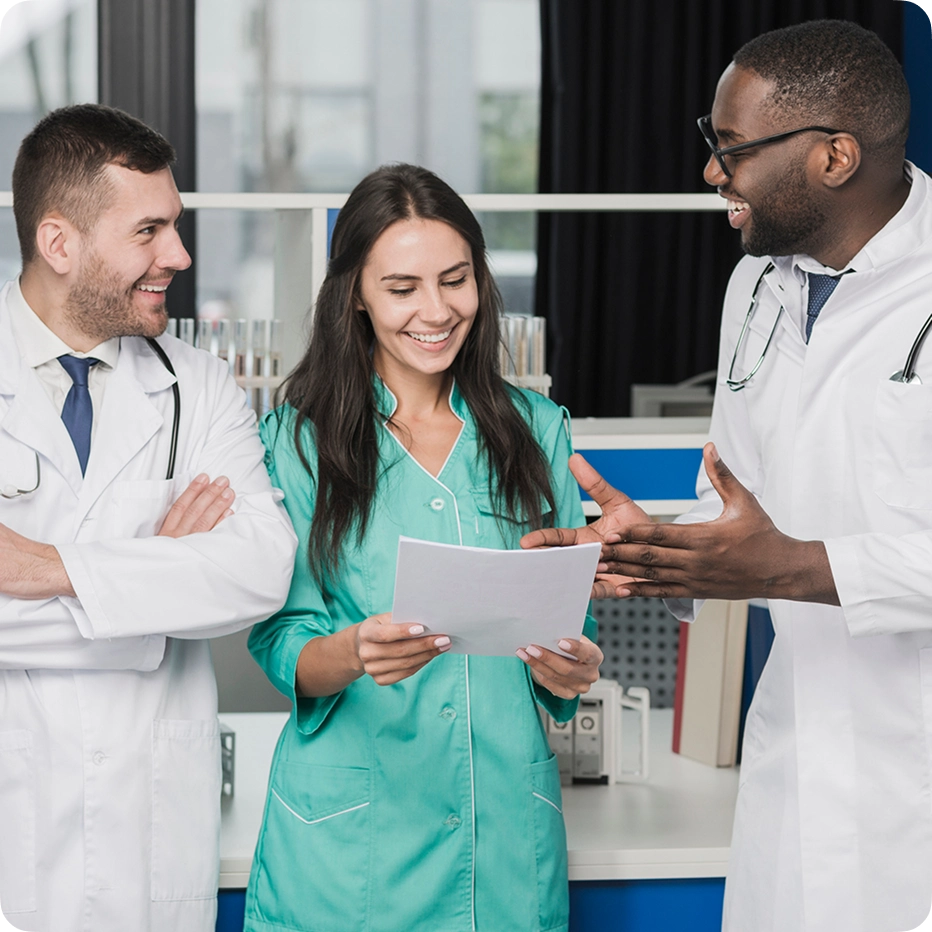 Doctors offering primary care and chiropractic care orlando gathered around a chart