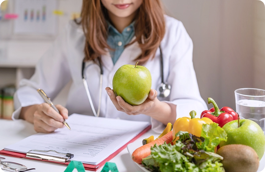 Nutritionist looking at an apple for primary care services in orlando