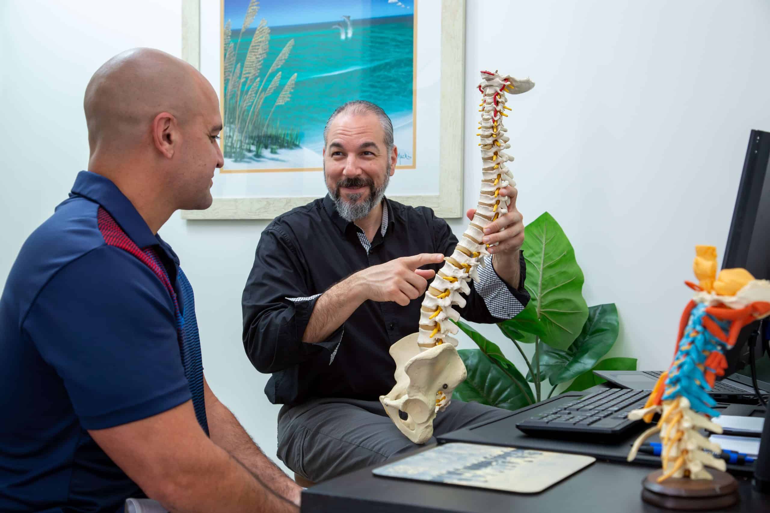 Chiropractor in Orlando showing patient how their spine is shaped