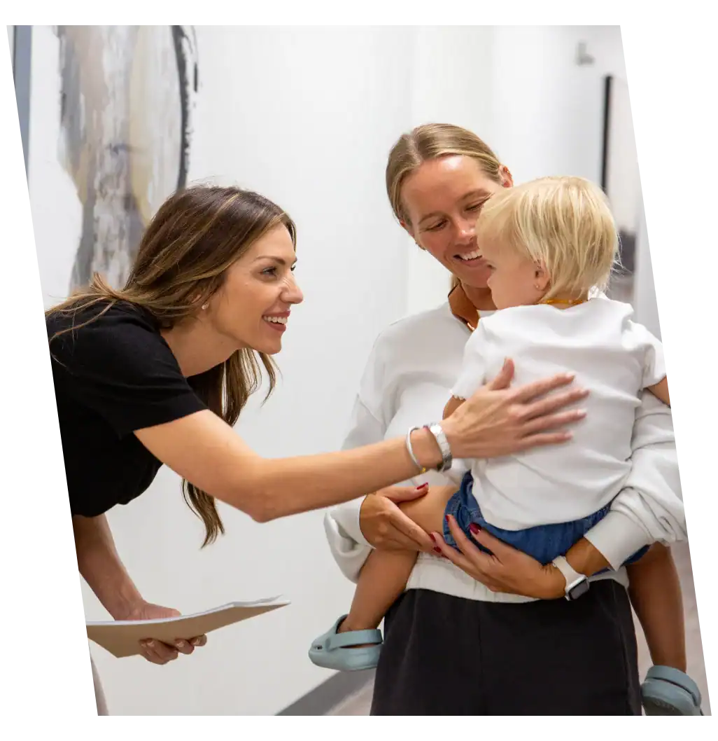 Doctor comforting child with back pain